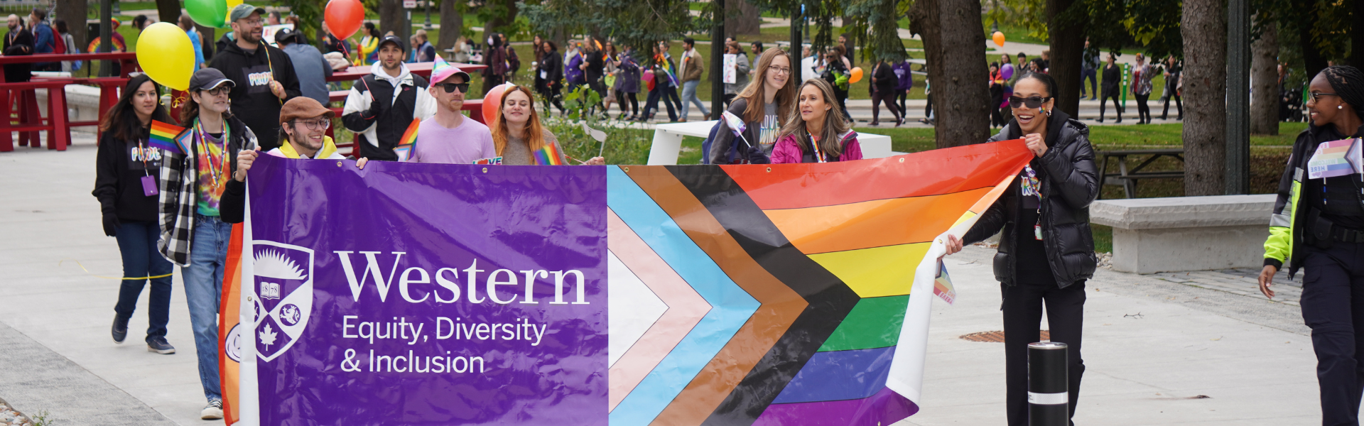 A photo of students and staff walking during the fall pride parade.