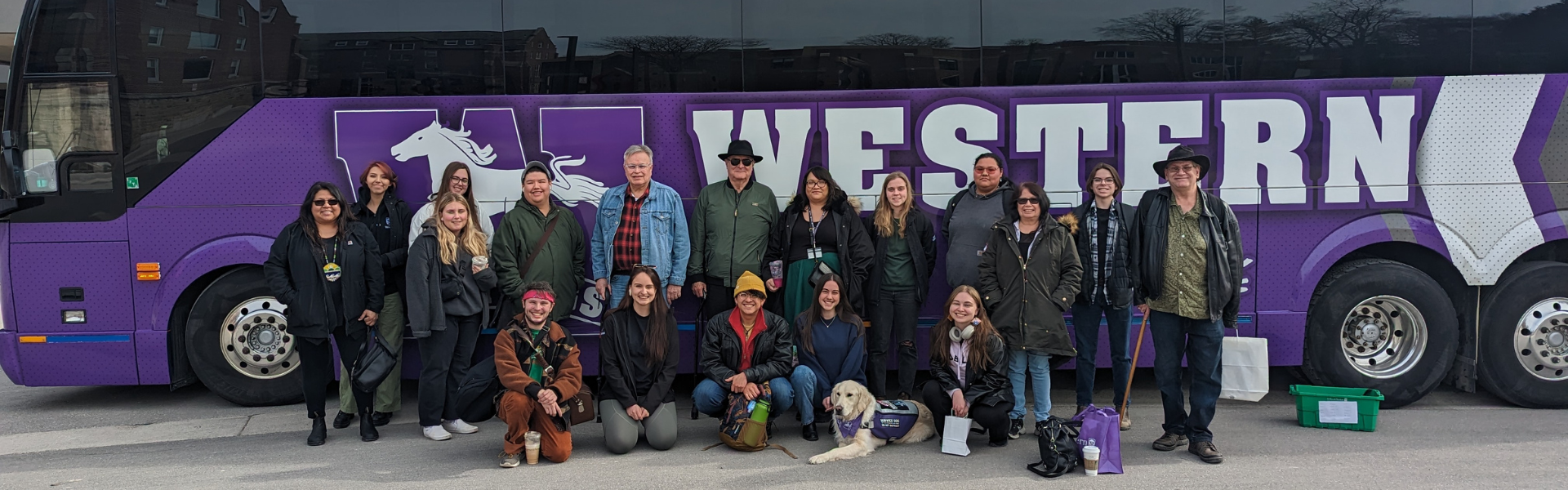 A photo of participants from the aunties and uncles program in front of a Western bus.