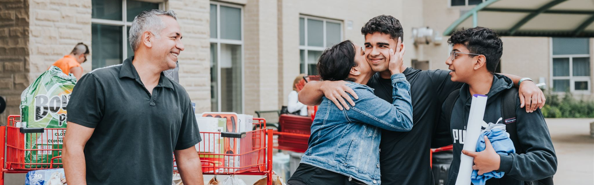 Parents dropping off their child during first year move-in day.